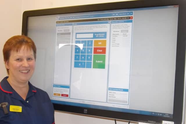 Quality matron Hazel Moore with the Web V system which is now displaying the MUST tool.