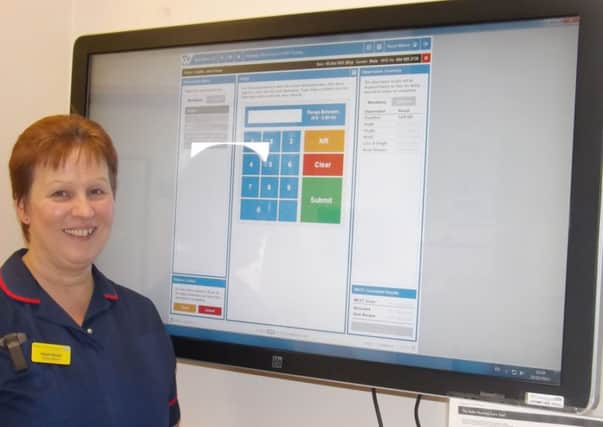 Quality matron Hazel Moore with the Web V system which is now displaying the MUST tool.