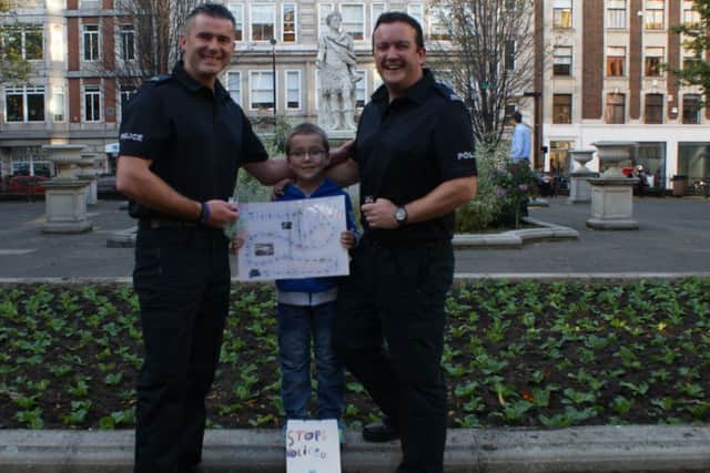 Jayden Prestwood with PC Jon Peacock and PC Rich Precious and the game he invented.