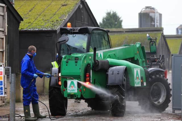 A farm vehicle is hosed down as preparations begin for a cull of ducks at a farm in Nafferton, East Yorkshire operated by Cherry Valley after a bird flu outbreak. Photo: Lynne Cameron/PA Wire