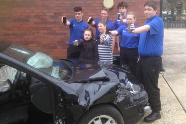 Pictured are all the youngsters warning of the serious consequences of texting whilst driving. Front row Chloe and Rosie surrounded by Grimsby Institute students.