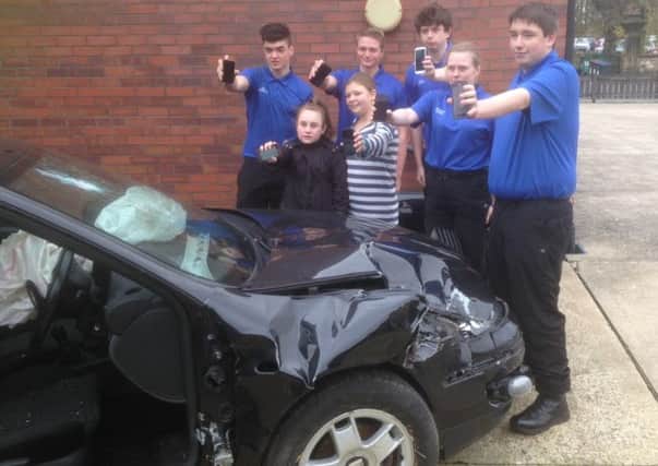 Pictured are all the youngsters warning of the serious consequences of texting whilst driving. Front row Chloe and Rosie surrounded by Grimsby Institute students.