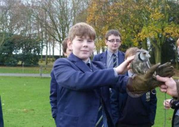 A Year Seven pupil at Ranby House meets a feathered friend during a birds of prey demonstration at the school
