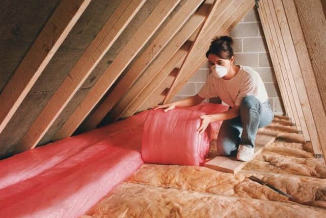 Undated Handout Photo of someone insulating the roof. See PA Feature LIFESTYLE DIY. PA Photo/B&Q. / loft insulation
