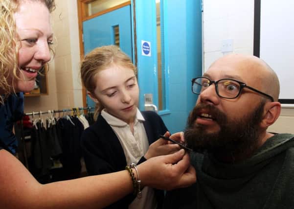 Ben Stockdale from Corringham Primary School had his beard shaved for charity. Pupil at the school Tia Walford, seven, made the first cut.