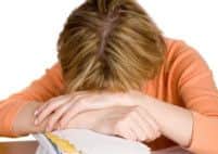 A woman exhausted with tax return form. a stack of bills by her side. Extracted. White background.