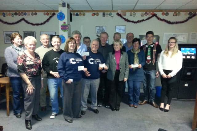 Proceeds from various fundraising events in Misterton are handed over to Cancer Research.