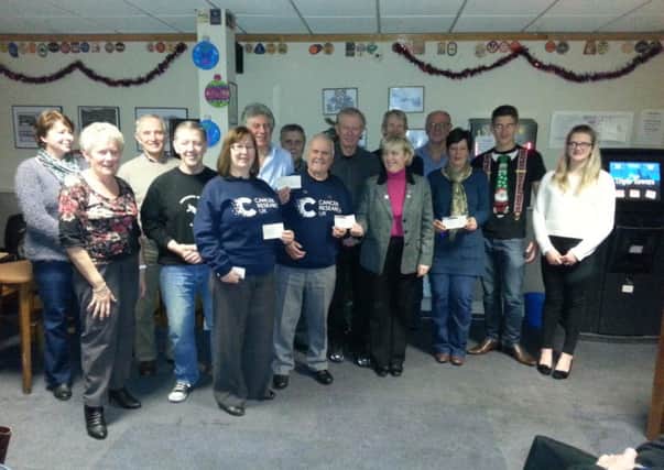 Proceeds from various fundraising events in Misterton are handed over to Cancer Research.