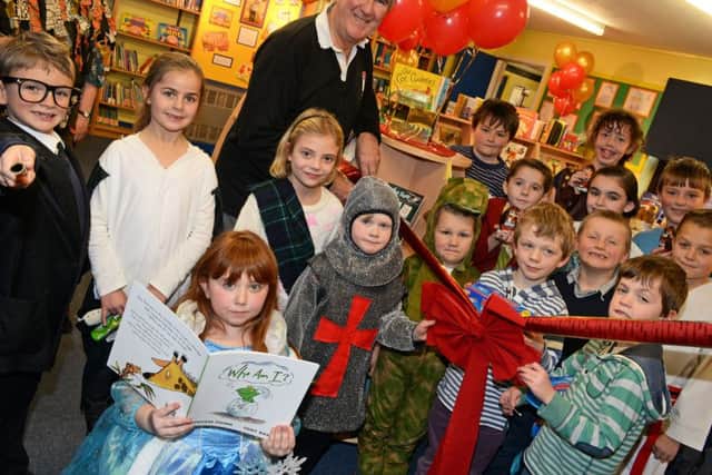 Author Gervase Phinn pictured officially opening Westwoodside C of E primary schools new library. Picture: Marie Caley NEPB 12-12-14 Library MC 1