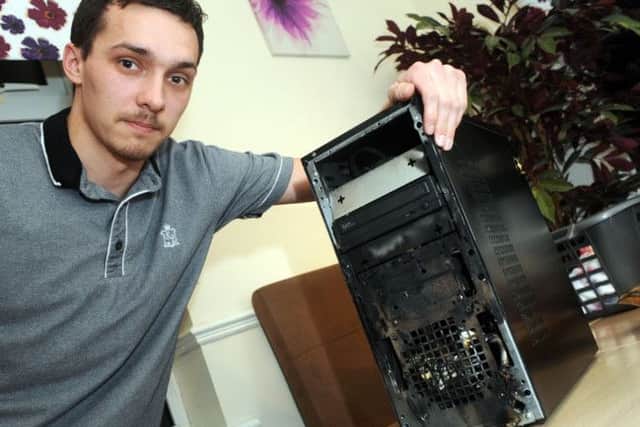 Ryan Seeley with the computer which caught fire in his Rhodesia home.