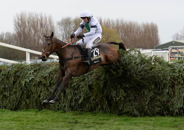 NATIONAL HERO -- Pineau De Re jumps the last fence en route to victory in the 2014 Crabbie's Grand National (PHOTO BY: John Giles/PA Wire).