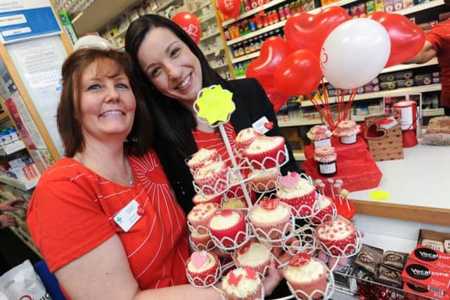Fundraiser for British Heart Foundation at Langold Pharmacy, staff dressing in red with bake sale and various fundraising activities. L-r is Amanda Gillatt and Zara Aleixo