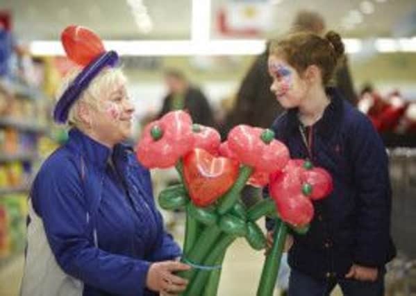 Fun Day: Staff member Jo-Ann Warmas with her valentine flowers and seven-year-old Olivia Chapman