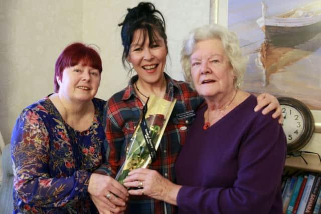 Jane Martindale and Edna Staveley present the Guardian Rose to Michelle Pressley at the Old Vicarage Care Home in Worksop.