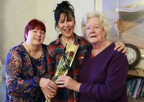 Jane Martindale and Edna Staveley present the Guardian Rose to Michelle Pressley at the Old Vicarage Care Home in Worksop.