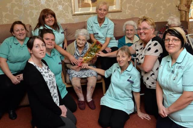 Staff at The Old Vicarge Care Home were nominated for a Guardian Rose from all the residents, pictured are some of the staff recieving the rose from resident Anne