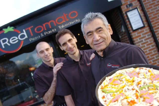 Parviz Hayati (front) and his sons Darius and Comron Hayati at Red Tomato.
