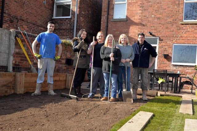 Forces Support charity give a garden makeover to Jane Elliott, pictured from left are Ritchie Howard of Forces Support, Gemma Wild, Beck Elliott, Jane Elliott, Sue Ellis and Andrew Morton of Forces Support