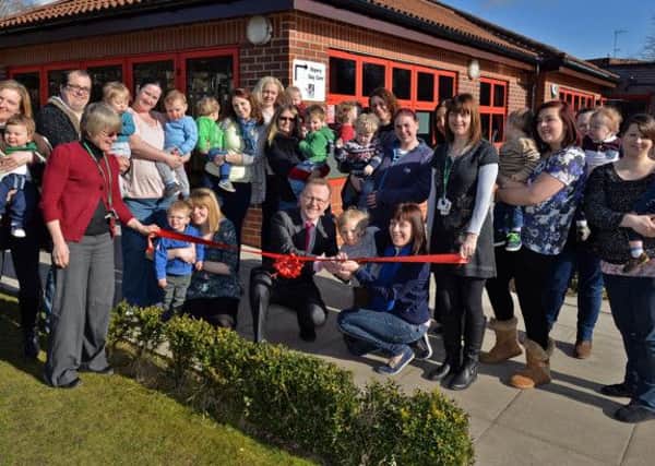 Official launch of Gainsborough Children's Centre, parents and children help to cut the ribbon