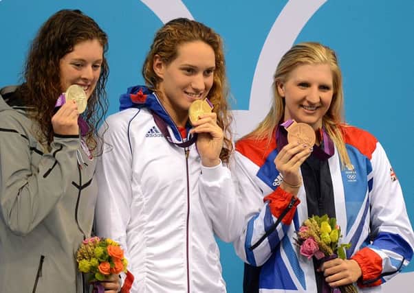 Camille Muffat (centre), celebrates her gold medal win with USA's silver winner Allison Schmitt (left) and Great Britain's bronze winner Rebecca Adlington (right) after the Women's 400m Freestyle final.