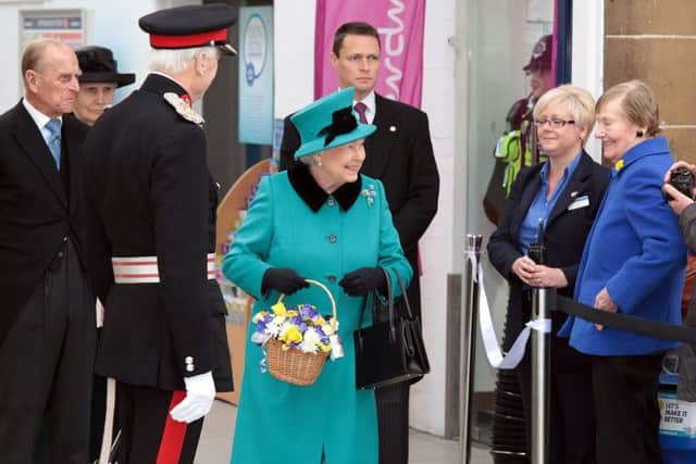The Queen is greeted by the public at the station