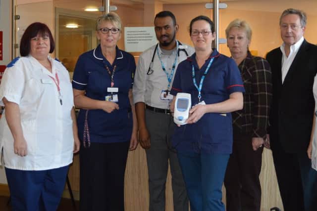 Pictured with the INR Machine are Chris and Andrea Mallinson and staff from the Emergency Department.