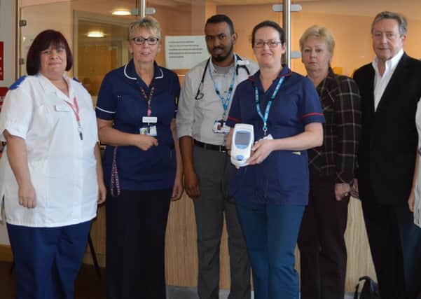 Pictured with the INR Machine are Chris and Andrea Mallinson and staff from the Emergency Department.