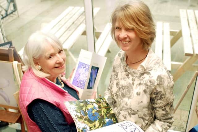 Art student Janet Hayes (left) and local artist and illustrator Helen Silcock with copies of Janet's first book, Flowers By Design