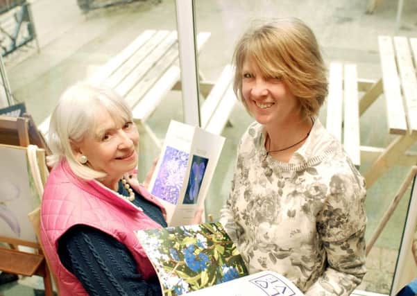 Art student Janet Hayes (left) and local artist and illustrator Helen Silcock with copies of Janet's first book, Flowers By Design