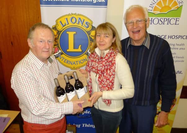Isle of Axholme Lions held a quiz in Haxey Memorial Hall in aid of Lindsey Lodge Hospice. Pictured is question master Terry Condliff presenting the winning team captain Lorraine Pepper with the team's prize, watched by event organiser Peter Lindley.
