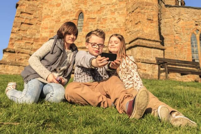 Ella (12), Harry (11) and Natasha (10) get snapping for the West Lindsey Photo Competition 2015 up at the Ramblers Church, Walesby.