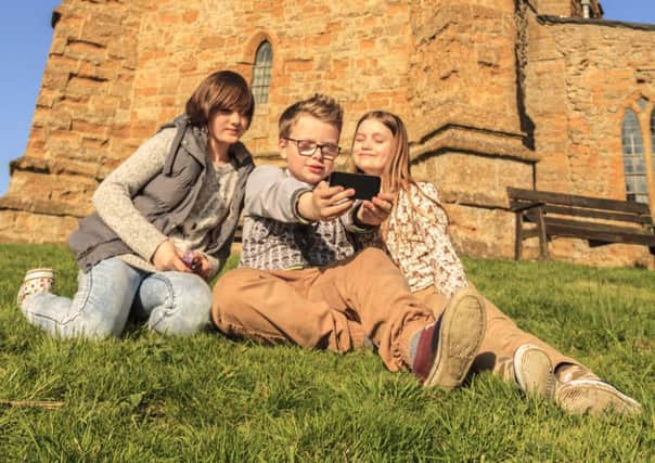 Ella (12), Harry (11) and Natasha (10) get snapping for the West Lindsey Photo Competition 2015 up at the Ramblers Church, Walesby.