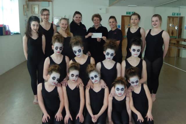 Competition Crew with Tracey Everett-Fox (right) and assistant Lauren Riley receiving a cheque for £200 in March towards the cost of their specialist costumes for competitive events from District Councillor Hazel Brand, funded from her community grant budget.