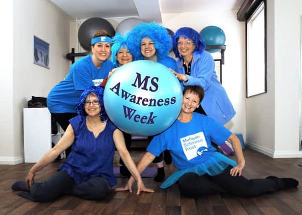 Jo Pritchard (centre) and participants from her pilates group, dressed in blue during classes to help raise awareness of MS during the Bold in Blue campaign