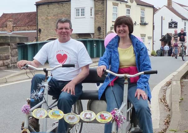 Side by side on a bike made for two are Pete and Lesley Riley in West Stockwith. Picture: Trevor Halstead