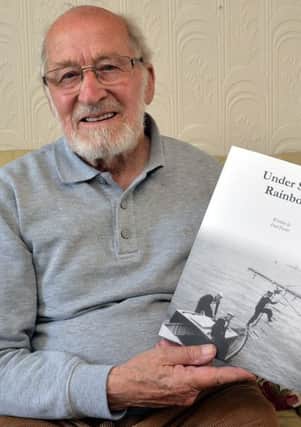 Authur Fred Foster with his book, Under Seven Rainbows