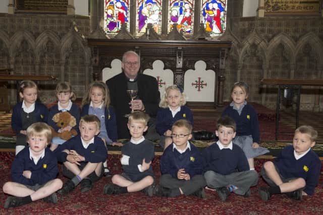 Rev Jeremy Green shows reception puils from Westwoodside School around St Nicholas Church at Haxey