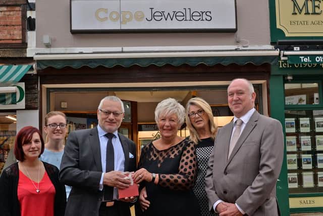 Christine Ampson is retiring from Cope Jewellers after 26 years of service, Christine is pictured recieving a gift from Andrew Cope watched by colleagues Alan Burrows, manager, Becky Daly, Amie Crooks and Margaret Young