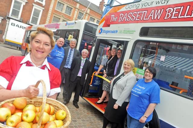 Coun. Pam Skelding cuts the ribbon to launch the Bassetlaw Belles bus service in Retford Market Place on Friday morning.