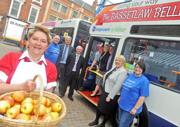 Coun. Pam Skelding cuts the ribbon to launch the Bassetlaw Belles bus service in Retford Market Place on Friday morning.