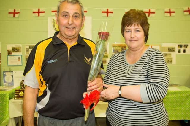 Coach Terry Gilham receives the Guardian Rose from Penny Miller the secretary of the Worksop Falcons Junior Badminston Club - Photo By James Williamson
