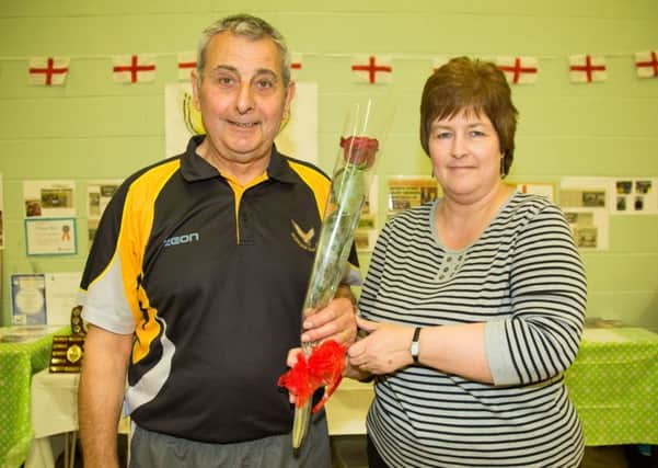 Coach Terry Gilham receives the Guardian Rose from Penny Miller the secretary of the Worksop Falcons Junior Badminston Club - Photo By James Williamson