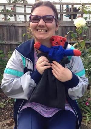 Beth Roe and her teddy that she knitted
