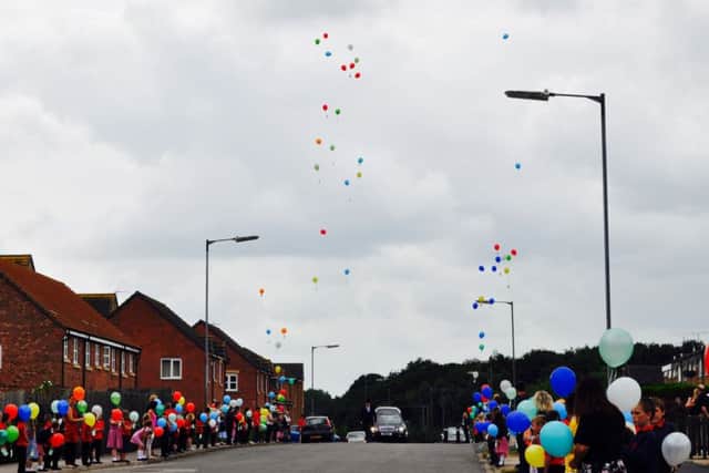 Pupils and staff from St Georges C of E Community Primary School released balloons on the day of Alfie Williams funeral as he went past the school