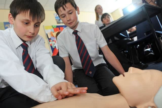 Year 8 pupils, Harry Anderson and Josh Tebbutt practice their first aid skills at the Queen Elizabeth High School on Friday.