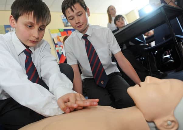 Year 8 pupils, Harry Anderson and Josh Tebbutt practice their first aid skills at the Queen Elizabeth High School on Friday.