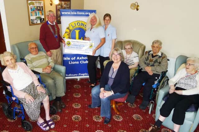 Isle of Axholme Lions presentation at Greenacres residential home, Crowle. President Graham Guest is pictured with activities co-ordinator Pat Boyle and carer Vicki Knight.