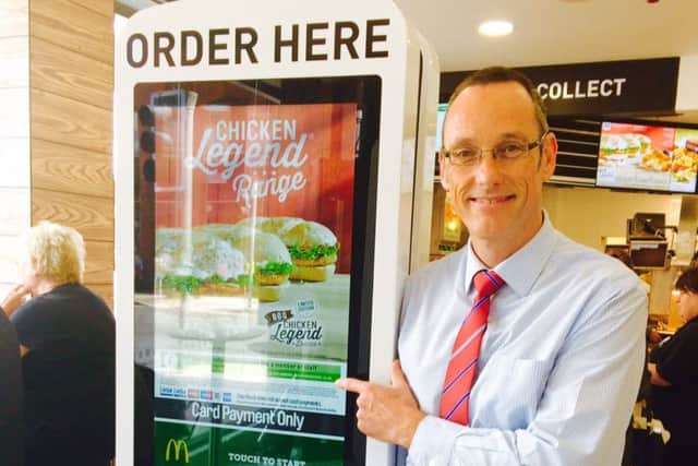 McDonald's franchisee Mark Clapham shows off the new high tech ordering point.