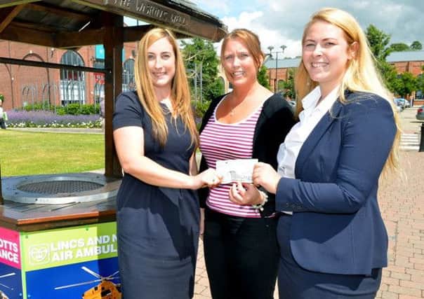 Marshalls Yard staff handing over the £1,000 cheque to the representative of Lincs and Notts Air Ambulance charity