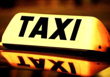 close up on a yellow taxi cab sign